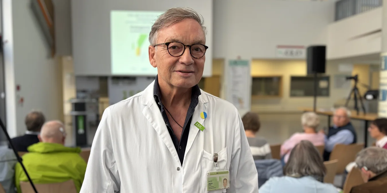 MediTALK Klinikum Dortmund - Prof. Dr. Michael Truß Portrait einer Person im weißen Kittel in einem Hörsaal